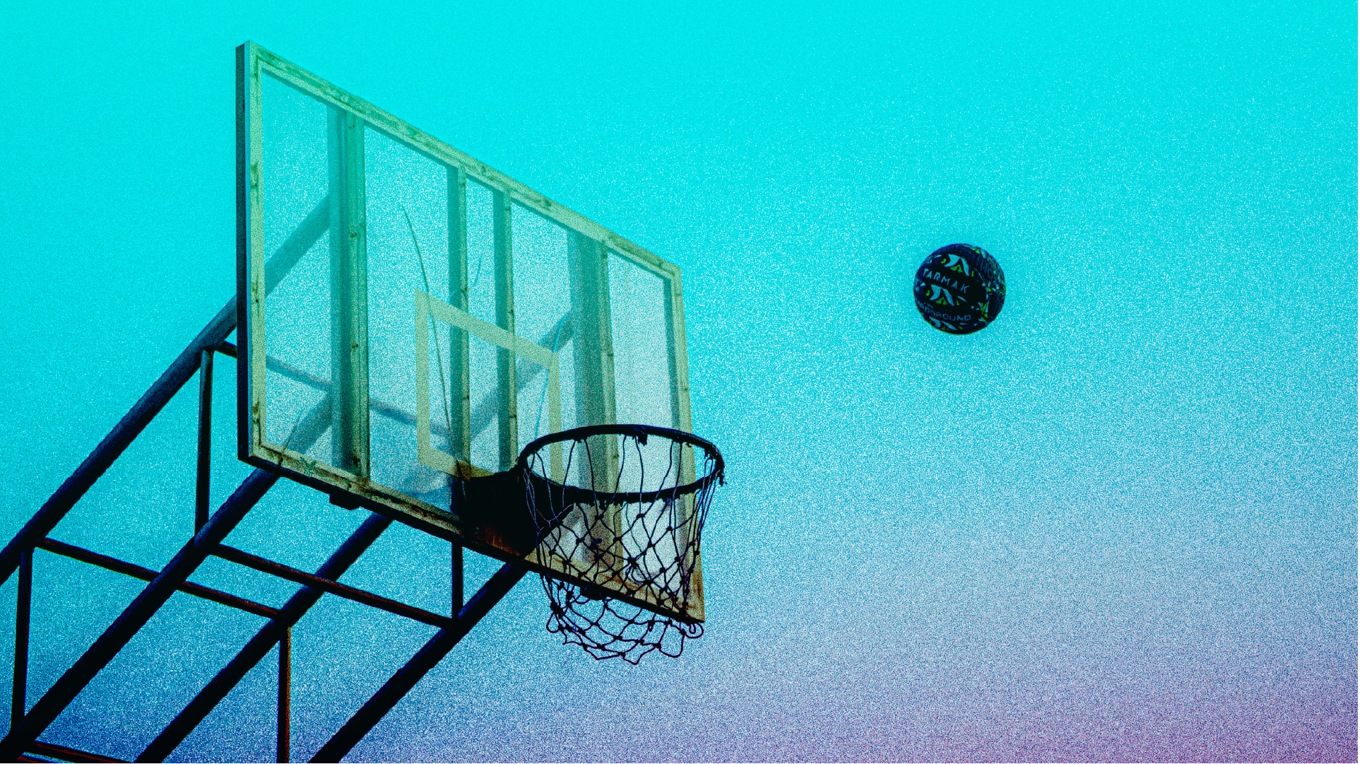 Outdoor basketball hoop and ball mid-air